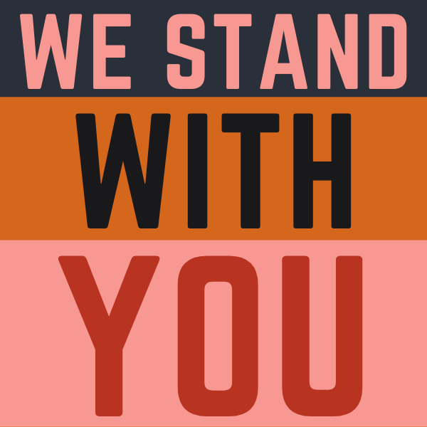 We Stand With You printed in capital letters on colored stripes