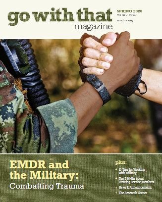 Two hands clasped wearing military fatigues
