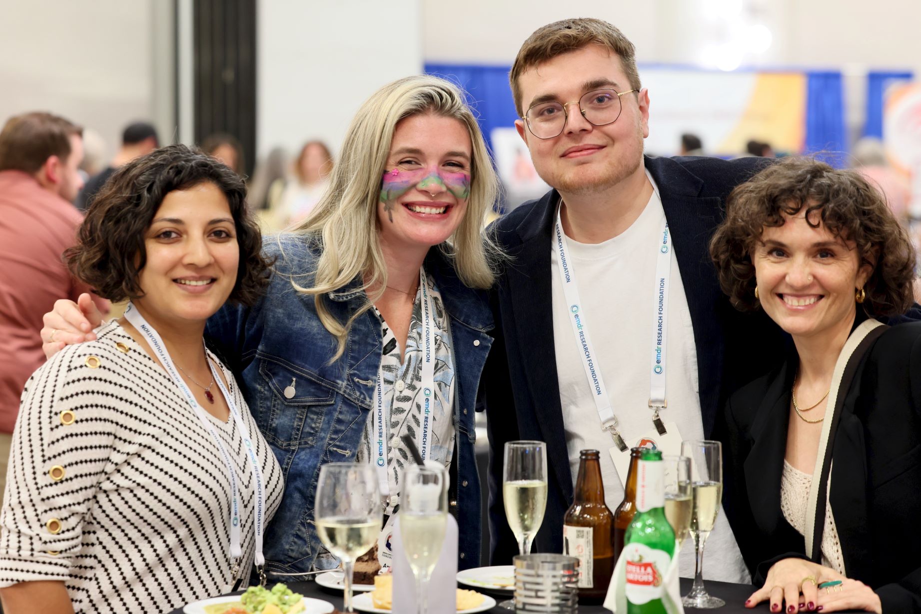 2025EMDRIAConferenceReceptionFriends Four smiling colleagues at the 2025 EMDRIA Conference